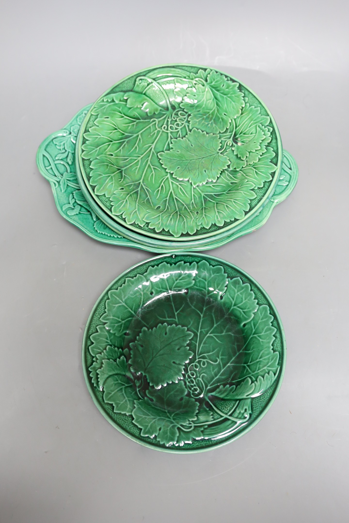 A collection of 19th century greenware leaf plates and a dish